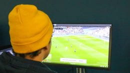 Student watching soccer on television.