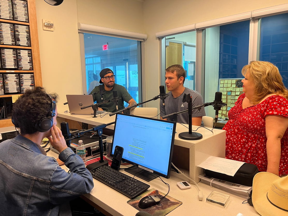  Mike Lynn, assistant director of Mako Media Network, and Mario D'Agostino, sports adviser, host The B-Side podcast with Mako Radio music director Weston Clark and Carey Courson, junior communication major. PHOTO BY ANDREW ROSE.